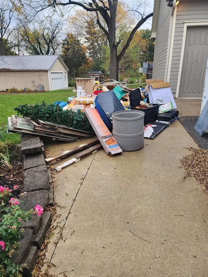 Dumpster being loaded with debris for Roofing Dumpster Rental in Lufkin